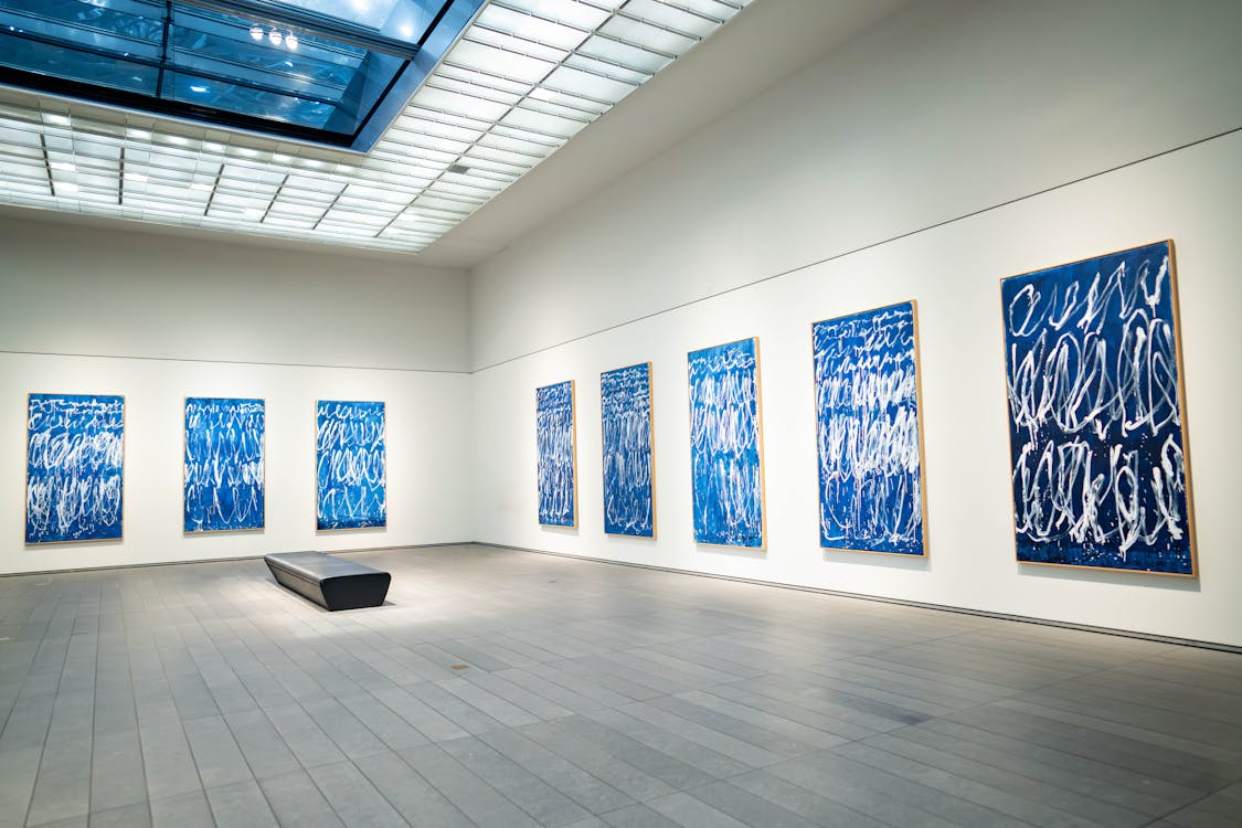 Large-scale contemporary paintings displayed in a museum gallery.