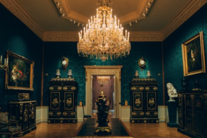 Museum interior showcasing statues, sculptures, and framed paintings on display