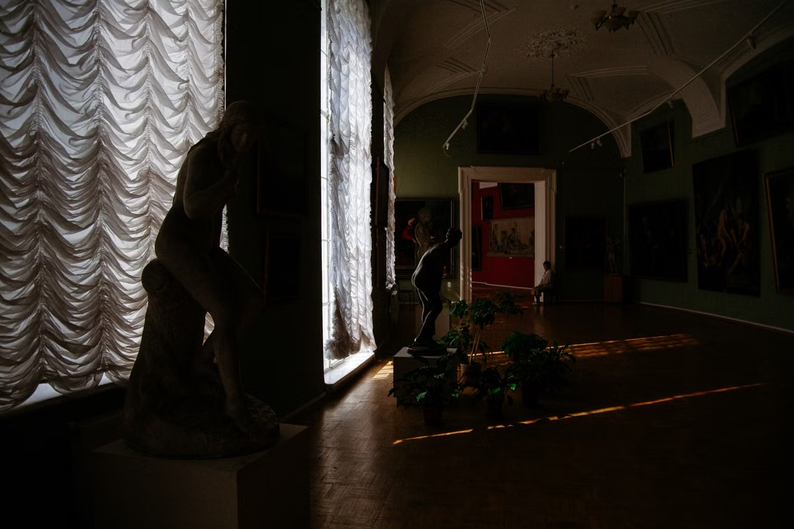 Sculptures displayed inside a museum gallery.