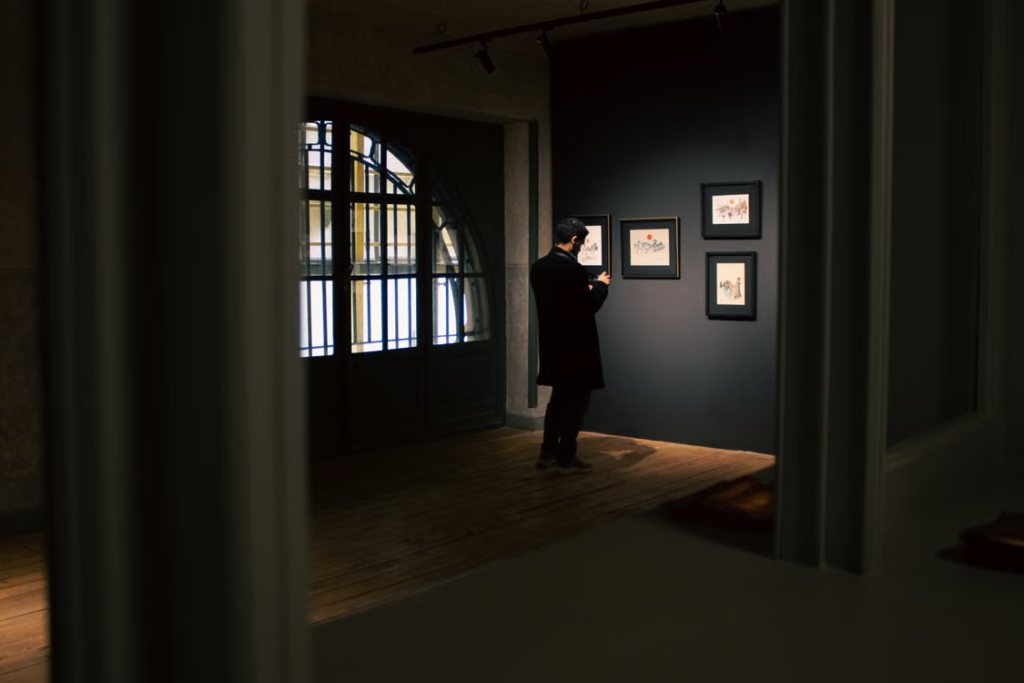 Art collector viewing artwork in a gallery.